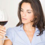 Woman tasting red wine